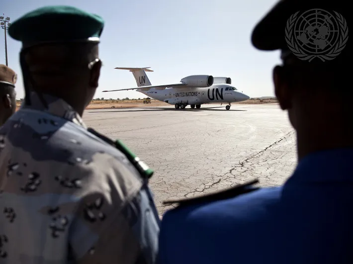 Two soldiers look at UN plane